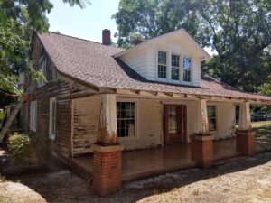 an old, run down home with about to be painted exterior by Superior Colors Painting Services