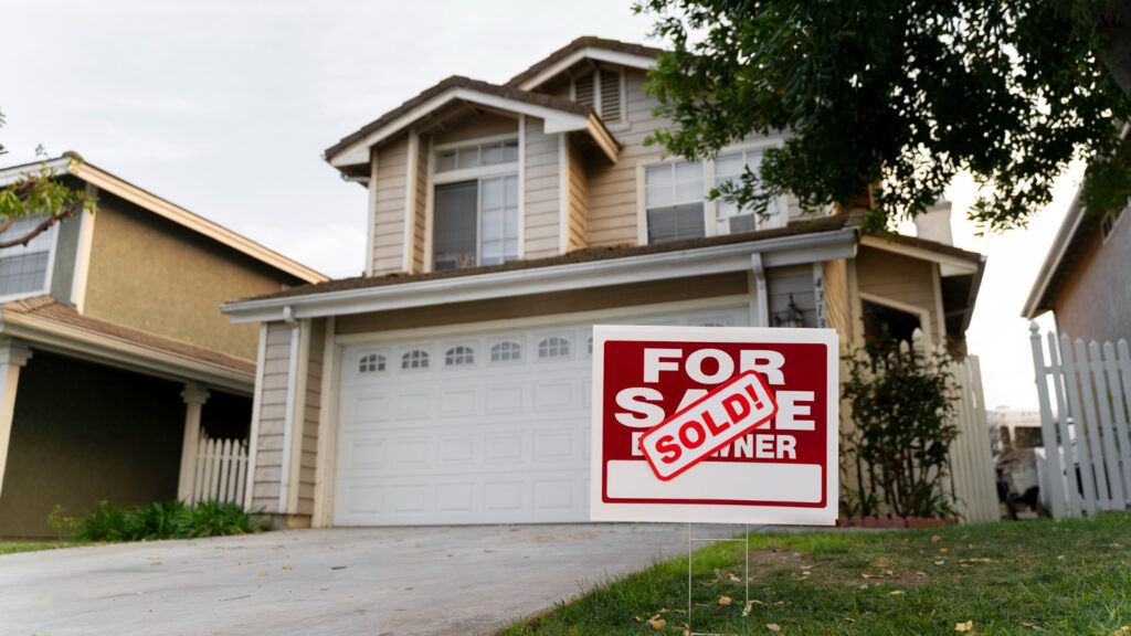 Home with sold sign in front yard